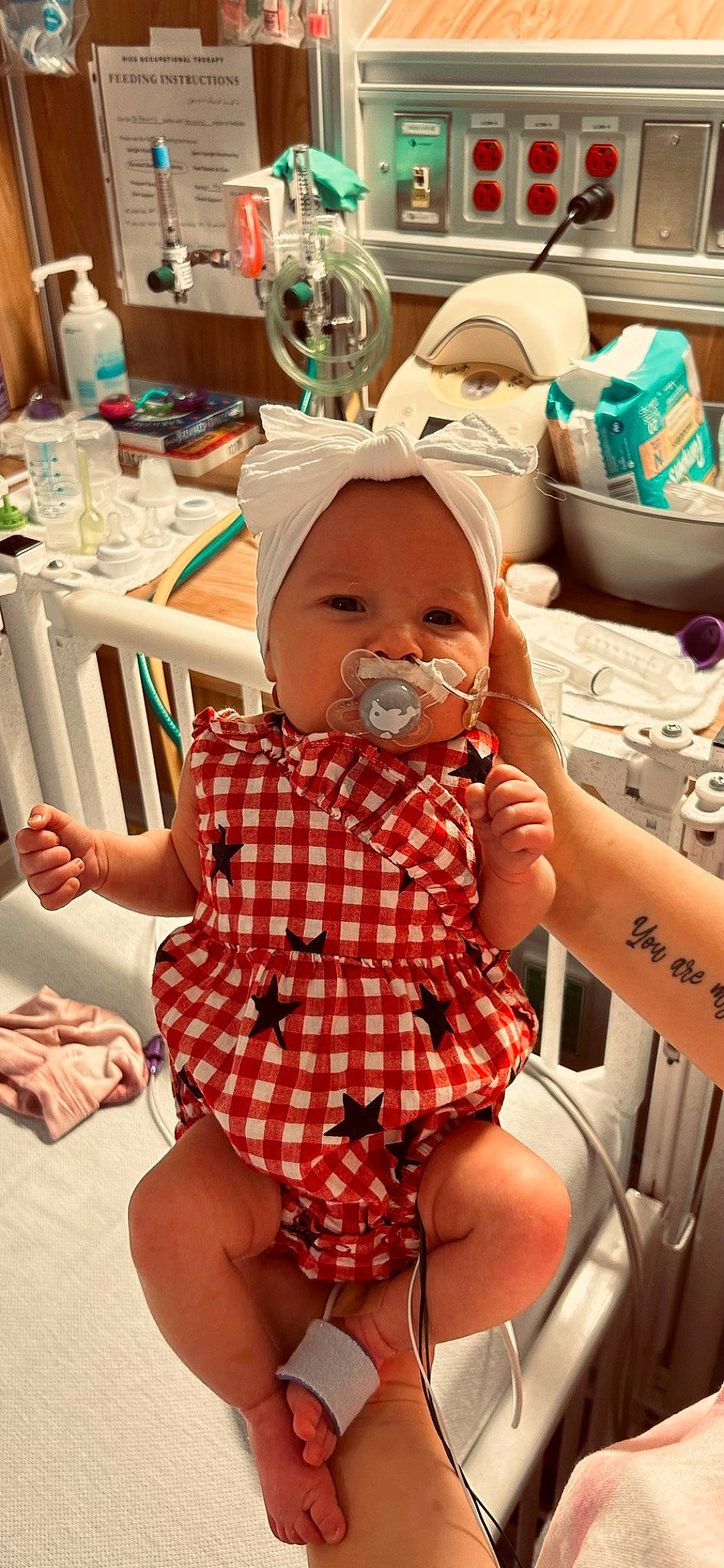Everleigh Adams is registered to the contest to win money with this photo: baby, chair, child, event, finger, fun, happy, hat, headwear, human_leg, mouth, pattern, people, person, plaid, room, shipping_box, skin, tartan, thigh