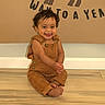 Grayson joined the competition — help win amazing prizes! toddler, child, smiling, happy, overalls, brown_clothing, barefoot, sitting, wooden_floor, indoor, face, head, cute, young_child, person, skin, playful, tongue_out, wall, letters