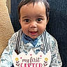 baby, child, smiling, face, bow_tie, shirt, suspenders, couch, indoors, celebration, holiday, easter, text_overlay, cute, portrait, happy, young_child, clothing, sitting, hands