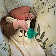 Emerson joined the competition — help win amazing prizes! baby, newborn, sleeping, hat, pacifier, hand, clothing, blanket, bed, face, infant, cute, cozy, soft, rest, child, nursery, pattern, floral, comfort