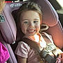 Taytum joined the competition — help win amazing prizes! child, car_seat, seatbelt, smile, girl, toddler, pink_shirt, sunlight, tattoo, vehicle_interior, window, happy, seat, hair, face, safety, toy, hand, person, closeup