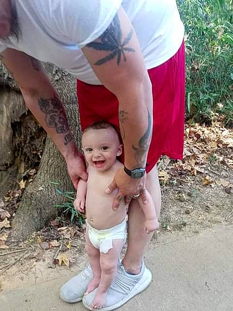 Buddy is registered to the contest to win money with this photo: abdomen, barechested, barefoot, chest, child, fun, gesture, grass, hand, happy, human_leg, joint, leg, leisure, muscle, people_in_nature, person, shorts, thigh, toddler