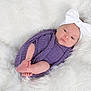 Maisley is registered to the contest to win money with this photo: baby, newborn, infant, headband, bow, swaddle, purple_wrap, blanket, fur_blanket, feet, toes, face, eyes, portrait, studio_photography, cozy, soft_texture, pink_skin, props, closeup