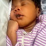 Ayanna is registered to the contest to win money with this photo: newborn, baby, sleeping, infant, portrait, close_up, face, eyes_closed, striped_clothing, lavender, purple, onesie, baby_clothing, blanket, bedding, cozy, peaceful, hand, indoors, hearts