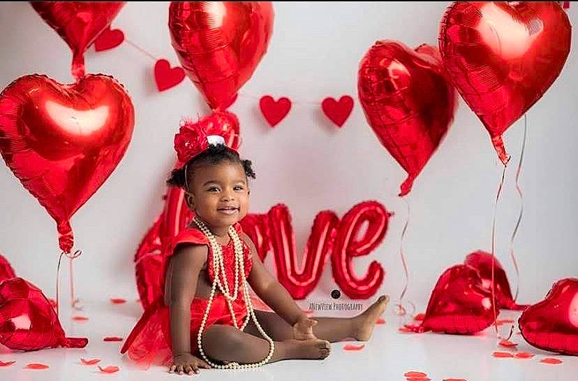 Sidney is registered to the contest to win money with this photo: balloon, event, happy, heart, holiday, human_body, joy, love, organ, party_supply, person, red, smile, valentines_day