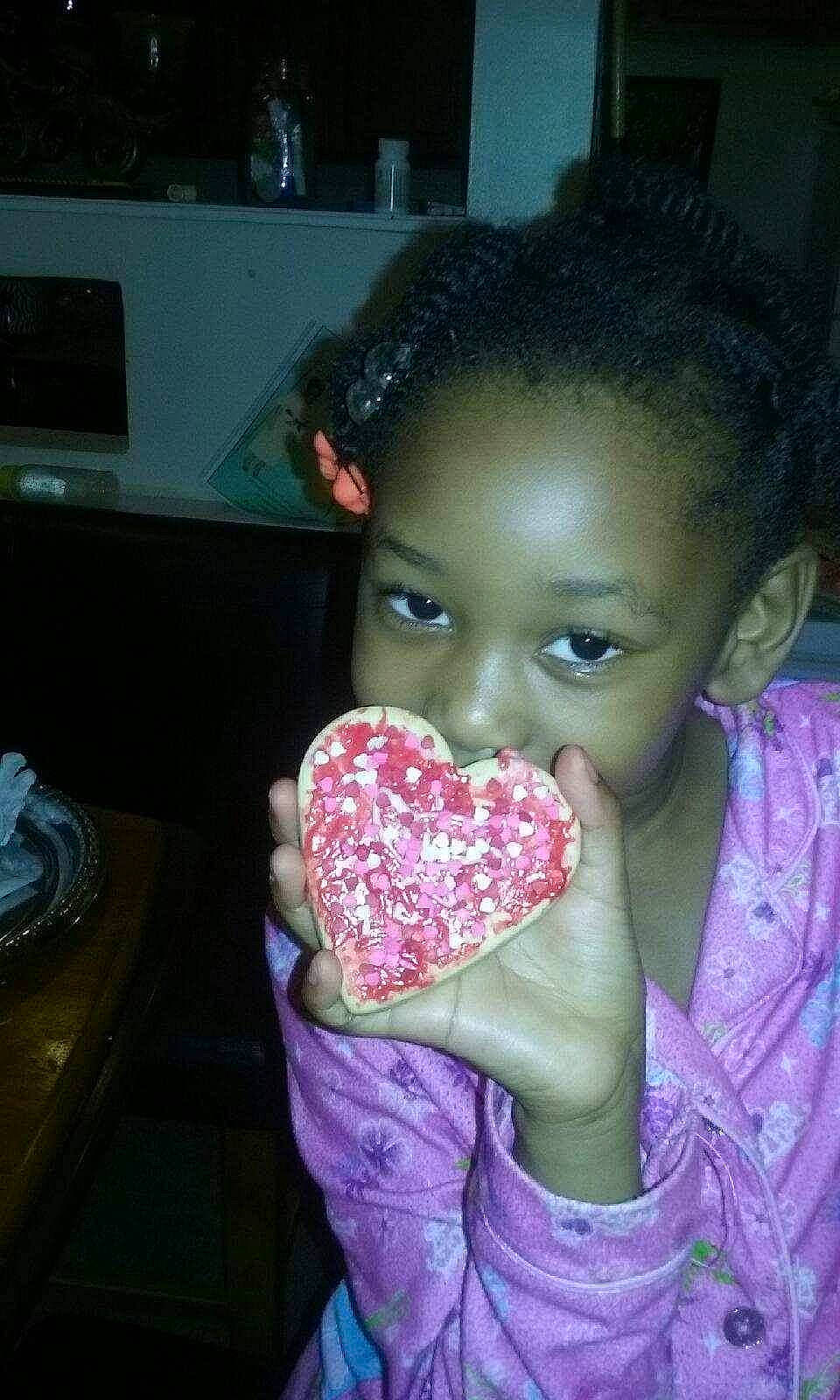 Lailah is registered to the contest to win money with this photo: child, food, mouth, person, pink, sprinkles