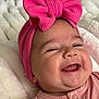 baby, infant, smiling, pink_bow, headband, cute, happy, face, cheeks, tongue, clothing, blanket, soft_texture, closeup, portrait, child, newborn, sleepy_eyes, indoors, cozy