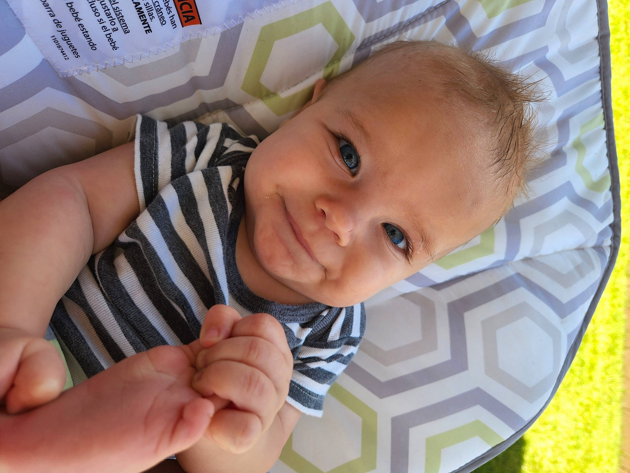 Cillian joined the competition — help win amazing prizes! baby, baby_products, baby_toddler_clothing, cheek, child, close_up, facial_expression, finger, gesture, grass, happy, iris, nail, pattern, people_in_nature, person, product, skin, smile, thumb