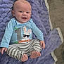 baby, child, smiling, blue_shirt, striped_pants, blanket, purple, soft_texture, happy, cute, infant, lying_down, clothing, face, feet, hand, indoors, person, portrait, cozy