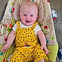 Leo joined the competition — help win amazing prizes! baby, smiling, yellow_overalls, baby_seat, indoor, child, happy, infant, face, clothing, cute, playful, colorful, patterned, sitting, person, furniture, bright, portrait, cheerful