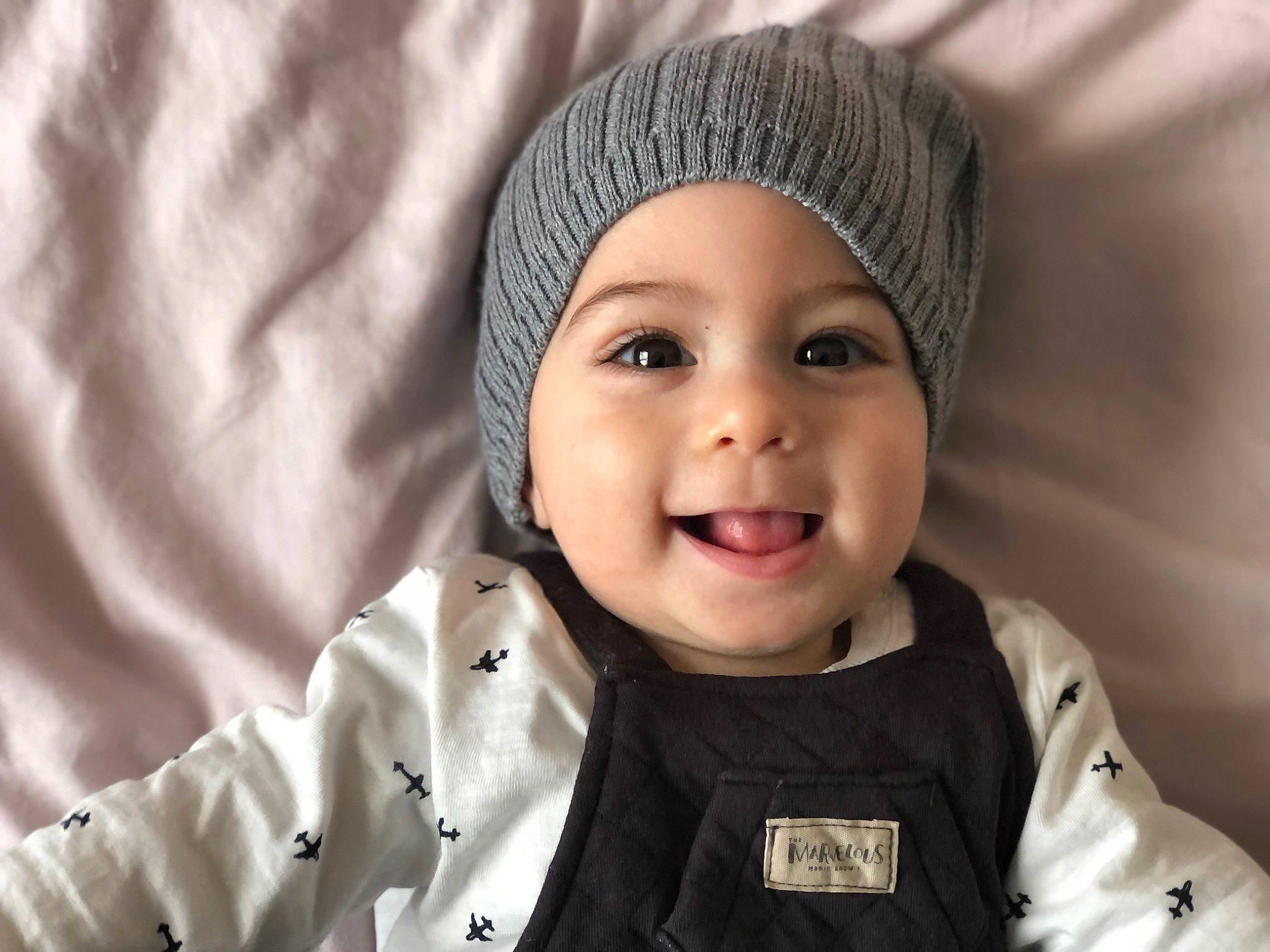 Adam participe au concours pour gagner de l'argent avec cette photo : baby, cap, cheek, chin, comfort, eye, eyebrow, face, happy, headgear, headwear, jacket, joy, lip, nose, outerwear, person, photograph, skin, sleeve