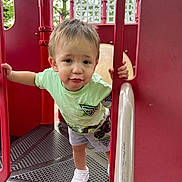 Zayden joined the competition — help win amazing prizes! active, child, curious_expression, daylight, fun, green_tshirt, hand_rails, metal_platform, outdoor, person, play_structure, playground, pouting, red_equipment, shorts, summer_clothing, toddler, trees, white_shoes, young_child