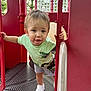 active, child, curious_expression, daylight, fun, green_tshirt, hand_rails, metal_platform, outdoor, person, play_structure, playground, pouting, red_equipment, shorts, summer_clothing, toddler, trees, white_shoes, young_child