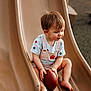 Zayden is registered to the contest to win money with this photo: baby, barefoot, casual_clothing, child, curious, daylight, football, fun, outdoor, park, person, play, playground, short_hair, sitting, slide, summer, toddler, toy, young_child
