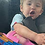 Zayden is registered to the contest to win money with this photo: baby, blanket, candid, car_seat, casual, child, clothing, colorful, comfort, expression, face, hair, indoor, person, pink_object, relaxed, seatbelt, toddler, toy, young_child