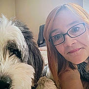 Panda is registered to the contest to win money with this photo: bed, casual, closeup, comfort, companion, dog, face, friendly, fur, glasses, hair, home, indoor, light, pet, portrait, relaxed, skin, smile, woman