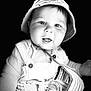 baby, child, infant, hat, bucket_hat, overalls, pacifier, smiling, tongue_out, portrait, black_background, cute, happy, closeup, clothing, baby_accessory, baby_boy, infant_clothing, face, person
