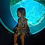 Lou a rejoint le concours — aidez-le/la à gagner de superbes lots ! child, girl, aquarium, underwater, window, blue, dress, sitting, shoes, portrait, side_profile, indoor, light, shadow, fish_tank, rocks, cute, young, thoughtful, environment
