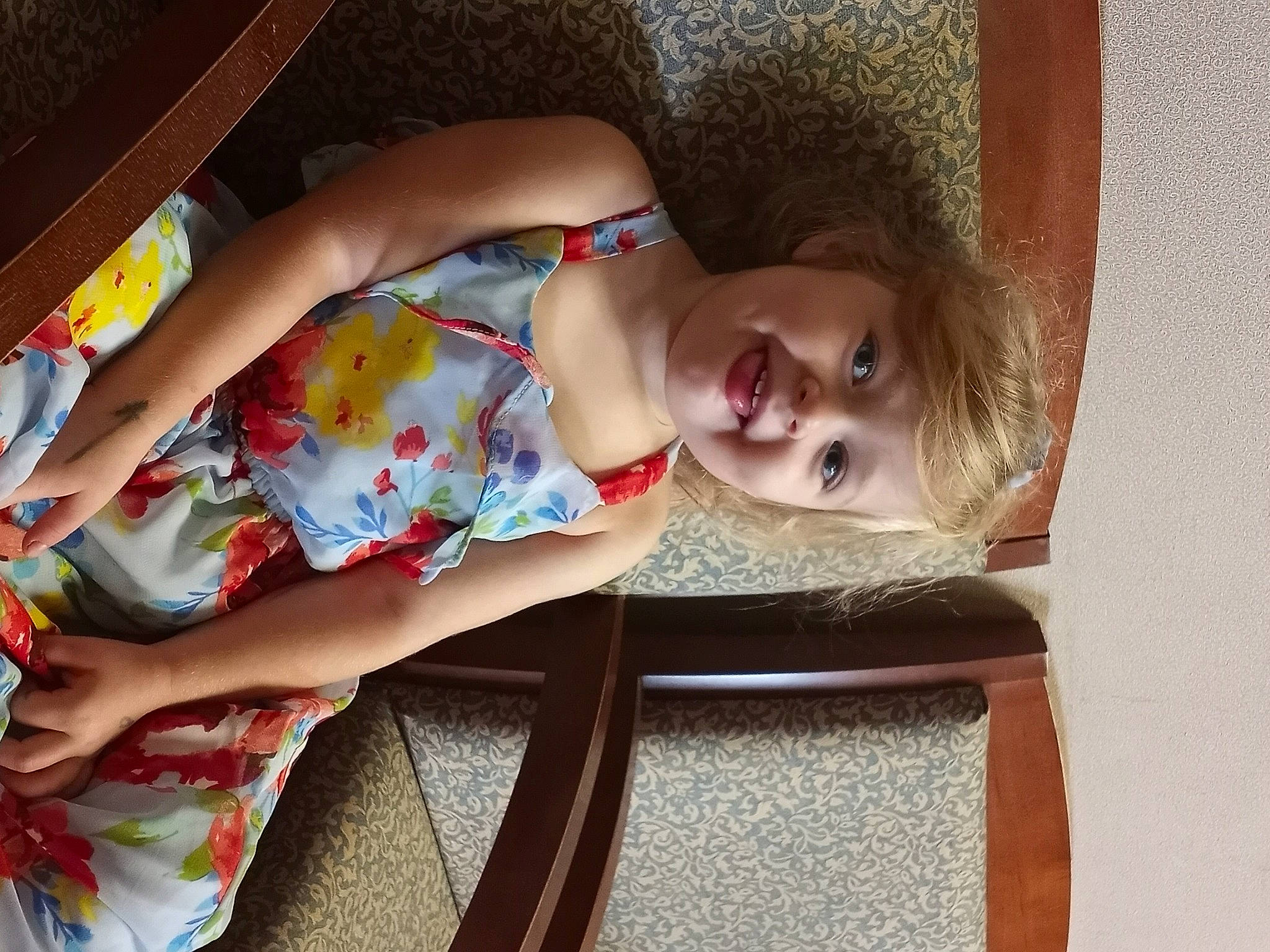 Taylynn is registered to the contest to win money with this photo: chest, child, dress, elbow, fun, happy, human_leg, joy, leg, leisure, pattern, person, room, skin, smile, textile, thigh, toddler, tree, trunk