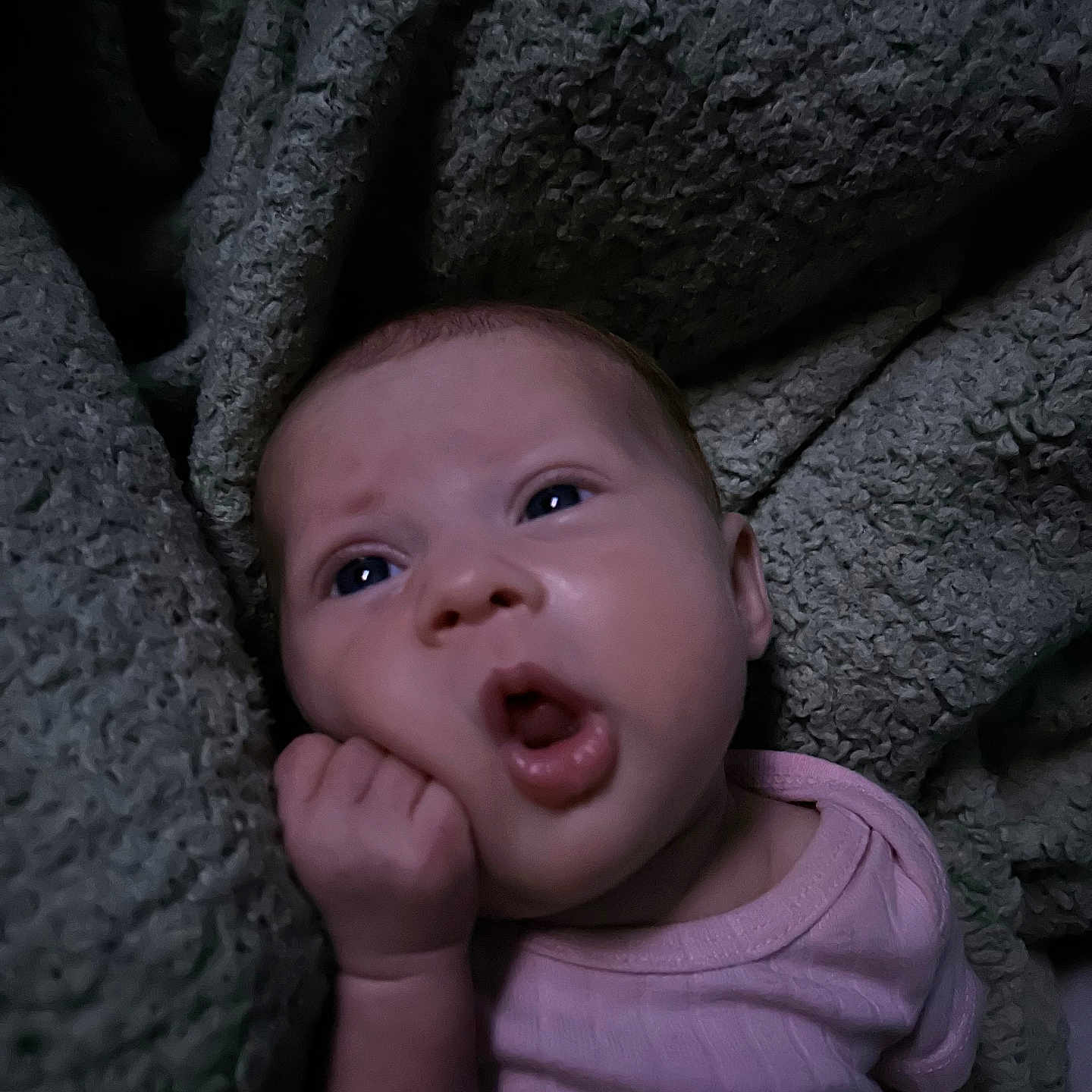 Esmeray is registered to the contest to win money with this photo: baby, blanket, closeup, clothing, cozy, cute, expression, face, hand, indoors, infant, lying_down, newborn, person, pink, portrait, resting, skin, sleepwear, soft