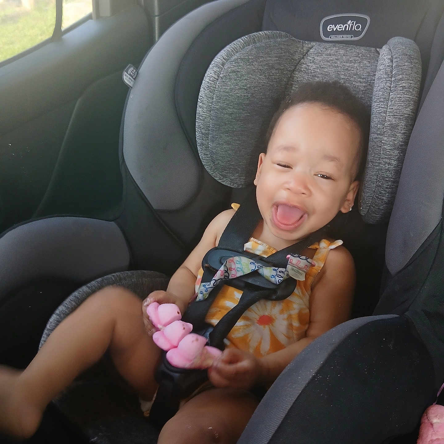 Cori-Christine is registered to the contest to win money with this photo: baby, car_interior, car_seat, child, clothing, cute, fun, happy, headrest, person, playful, safety, seat, seatbelt, smiling, sunlight, toddler, toy, vehicle, window