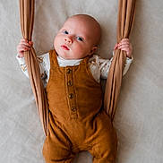 Waylon joined the competition — help win amazing prizes! baby, infant, newborn, overalls, romper, socks, hands, face, eyes, blanket, fabric, bed, portrait, indoor, cozy, soft_lighting, cute, small_feet, holding, expression