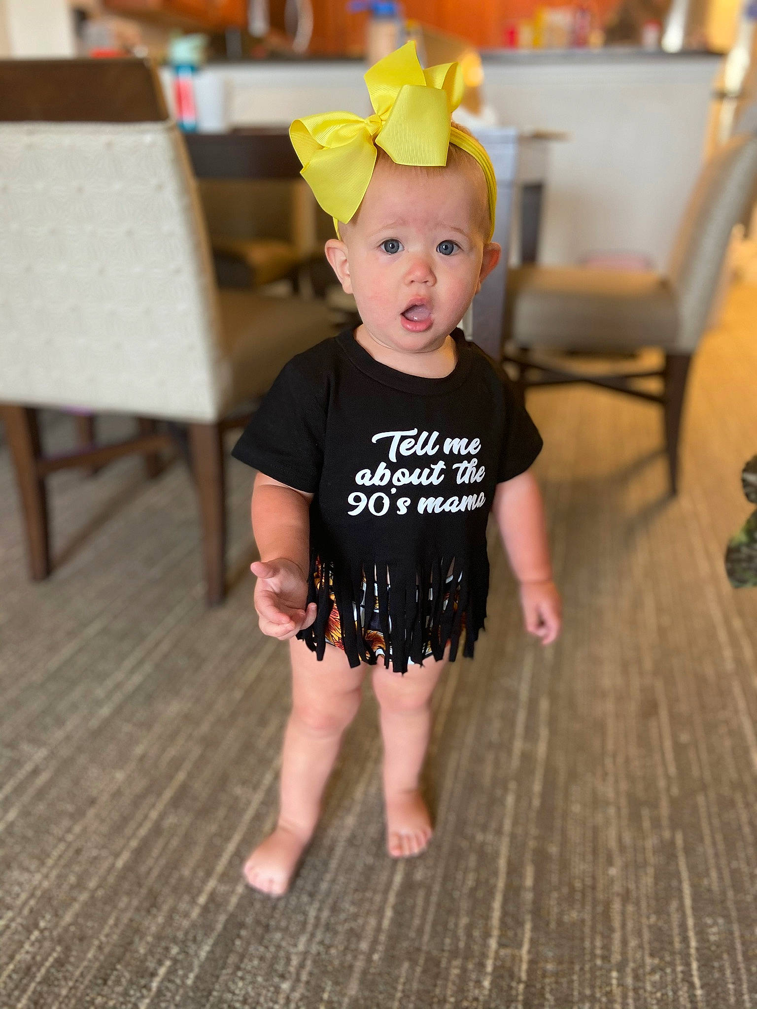 Lakyn joined the competition — help win amazing prizes! baby, baby_toddler_clothing, barefoot, child, event, fashion_accessory, floor, flooring, fun, happy, hardwood, head, human_leg, party_supply, pattern, person, sitting, sleeve, surprise, t_shirt