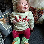 Myah is registered to the contest to win money with this photo: baby, infant, sitting, smiling, sweater, hohoho, green_socks, reindeer, couch, pillows, dog_photo, rooster_pillow, cozy, indoor, cute, holiday_theme, child, happy, portrait, clothing