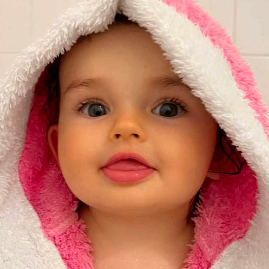 Honoria participe au concours pour gagner de l'argent avec cette photo : adorable, baby, bathroom, blue_eyes, bunny_ears, child, cute, expression, face, head, hooded_towel, indoor, person, pink, portrait, skin, soft_texture, tongue_out, towel, white