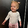Miley joined the competition — help win amazing prizes! toddler, child, girl, standing, pink_pants, white_shirt, hair_ties, smiling, indoor, door, black_background, cute, young_child, portrait, person, young_girl, hairstyle, casual_clothing, small_child, happy