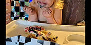 Miley is registered to the contest to win money with this photo: child, toddler, birthday, high_chair, cake, frosting, smiling, party, balloons, decorations, indoor, celebration, happy, face, messy, hair, feet, table, window, chair