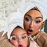 Mila participe au concours pour gagner de l'argent avec cette photo : baby, woman, towel, glasses, earrings, face, expression, indoor, portrait, cozy, hug, sweater, child, headwear, filter, fun, surprised, skin, person, family