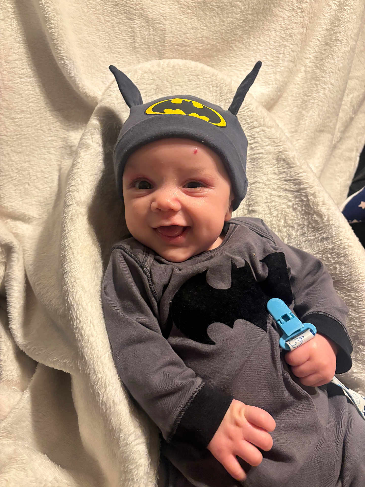 Deandre joined the competition — help win amazing prizes! baby, batman, cap, smile, pacifier, blanket, infant, cute, child, clothing, soft, happy, portrait, indoors, costume, hand, face, eyes, headwear, babywearing