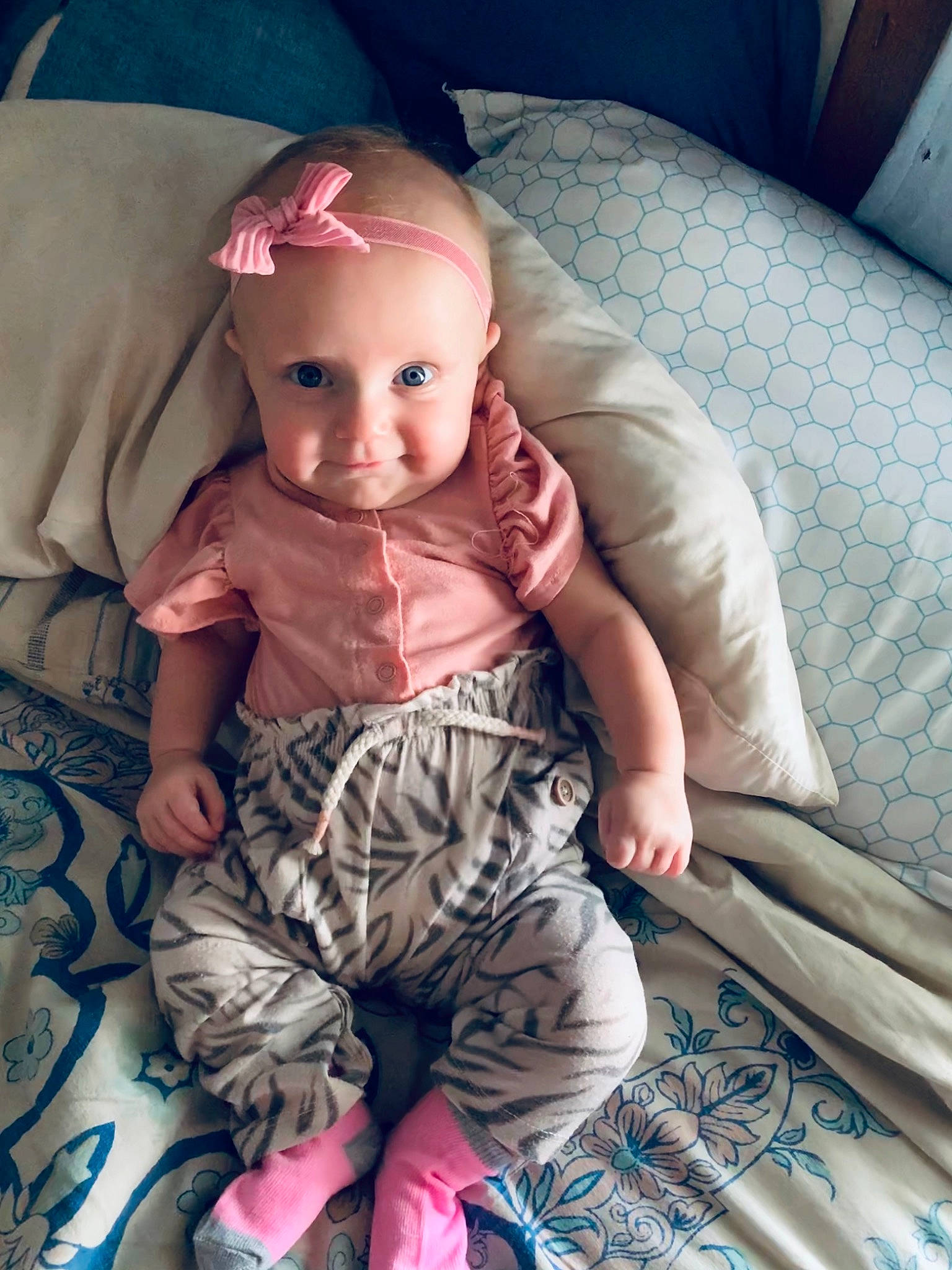 Korah is registered to the contest to win money with this photo: baby, baby_toddler_clothing, cheek, comfort, cool, doll, headwear, iris, leg, linens, lip, mouth, person, pink, skin, sleeve, smile, textile, thigh, toddler