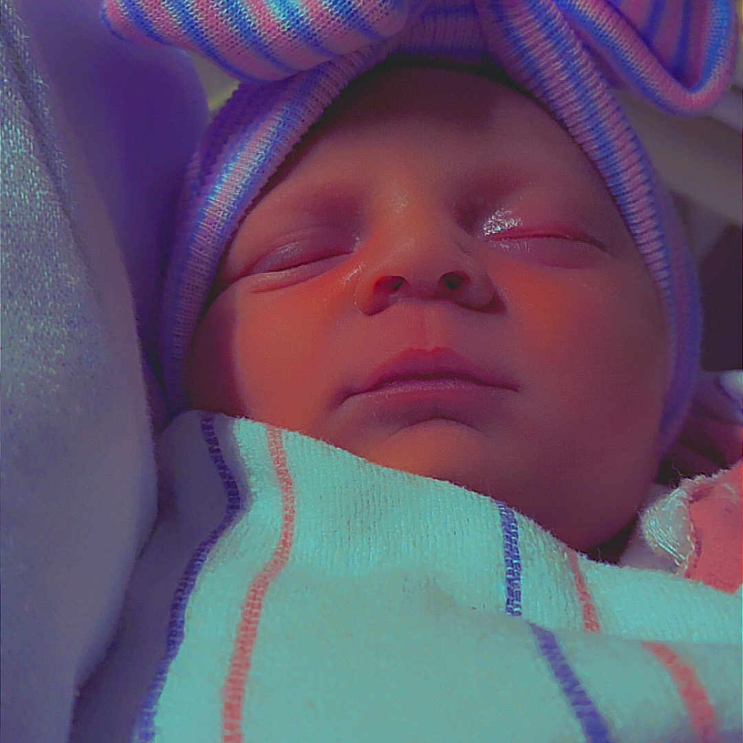 Liliana joined the competition — help win amazing prizes! baby, blanket, child, closeup, cozy, cute, face, hat, headwear, hospital, indoors, infant, newborn, peaceful, portrait, serene, sleeping, soft_lighting, striped, wrapped