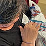 Eliana is registered to the contest to win money with this photo: newborn, baby, hospital, adult, person, blanket, breathing_apparatus, medical, gloves, scrubs, care, tenderness, holding, indoor, closeup, healthcare, patient, bracelet, black_shirt, hair