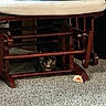 animal, carpet, cat, curious, cushion, cute, domestic, floor, furniture, indoor, kitten, pet, playful, resting, rocking_chair, small_animal, tortoiseshell, toy_mouse, wooden_chair, young