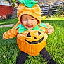Kionna is registered to the contest to win money with this photo: baby, child, pumpkin_costume, halloween, grass, outdoor, smile, cute, greenery, costume, holiday, festive, autumn, yard, playful, happy, toddler, seasonal, nature, fun