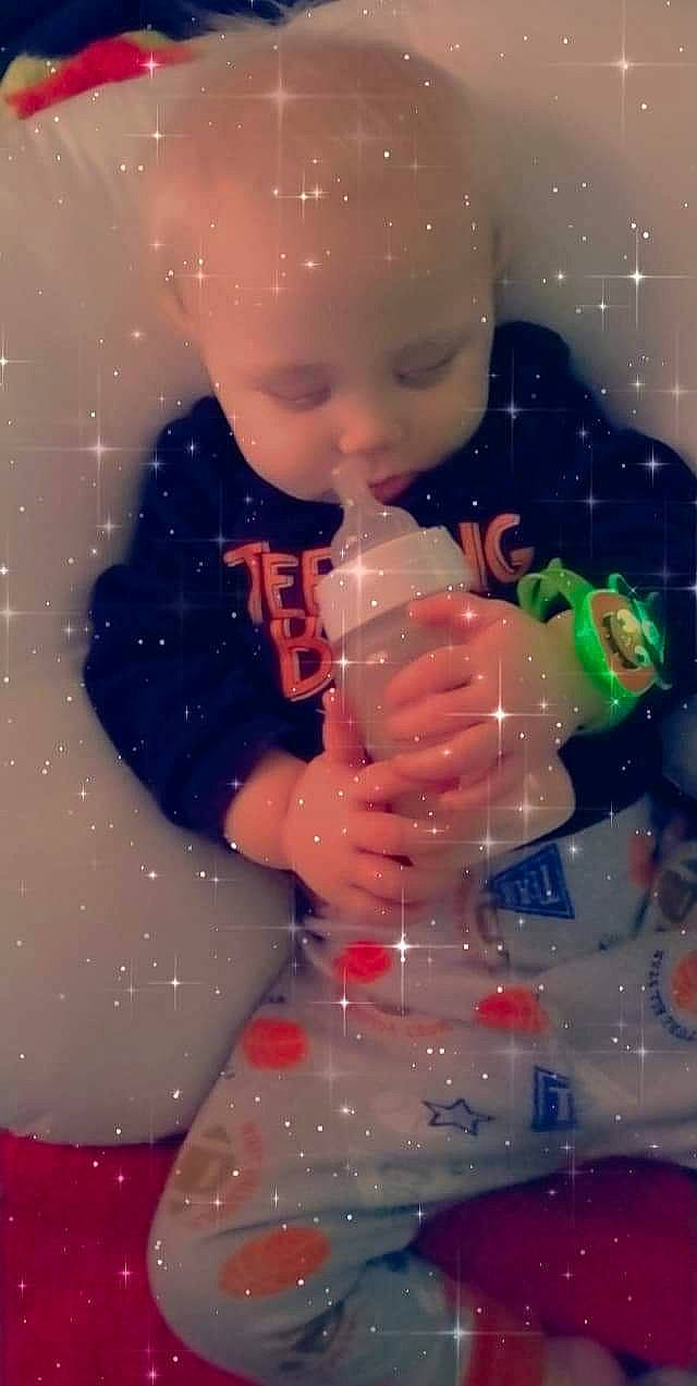 Justin is registered to the contest to win money with this photo: baby, baby_toddler_clothing, bathing, cheek, chest, drinkware, finger, hand, happy, head, human_body, leg, lip, nail, person, pink, plastic_bottle, thumb, toddler, toy