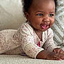 baby, child, smiling, happy, lying_down, onesie, heart_pattern, carpet, indoor, cute, infant, portrait, face, skin, hand, eyes, clothing, baby_girl, soft_texture, home