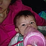 Roseley is registered to the contest to win money with this photo: baby, bottle, person, pink_hoodie, hand, face, indoor, child, feeding, closeup, casual_clothing, bedtime, relaxing, young_child, human, parent, infant, portrait, comfort, night