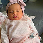 Viktoria participe au concours pour gagner de l'argent avec cette photo : baby, sleeping, pink_clothing, headband, bow, infant, indoors, soft_fabric, tights, dress, person, cute, peaceful, child, newborn, portrait, cozy, home, relaxed, resting