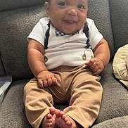 Elias is registered to the contest to win money with this photo: baby, smile, couch, clothing, feet, person, indoor, sitting, child, face, happy, pants, shirt, hands, toes, furniture, soft, cute, infant, relaxing