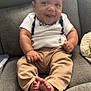 baby, smile, couch, clothing, feet, person, indoor, sitting, child, face, happy, pants, shirt, hands, toes, furniture, soft, cute, infant, relaxing