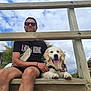 Snoop a rejoint le concours — aidez-le/la à gagner de superbes lots ! man, dog, golden_retriever, puppy, sunglasses, tshirt, wooden_steps, outdoor, sky, clouds, smiling, sitting, pet, leash, happy, daylight, nature, person, casual, bench