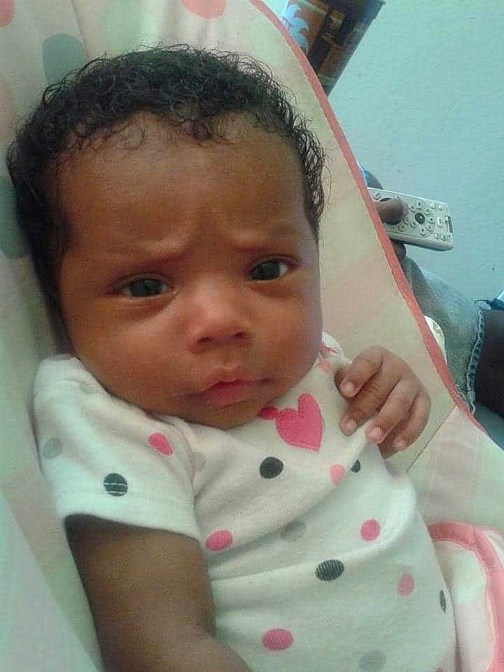 Amaralee joined the competition — help win amazing prizes! baby, infant, child, polka_dot, heart, clothing, face, curly_hair, hand, cushion, indoor, expression, looking, young_child, person, portrait, resting, cute, skin, head