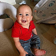 River joined the competition — help win amazing prizes! baby, child, smiling, indoor, carpet, red_shirt, denim_pants, happy, person, toddler, floor, toys, baby_gear, candid, cute, infant, sitting, face, portrait, home