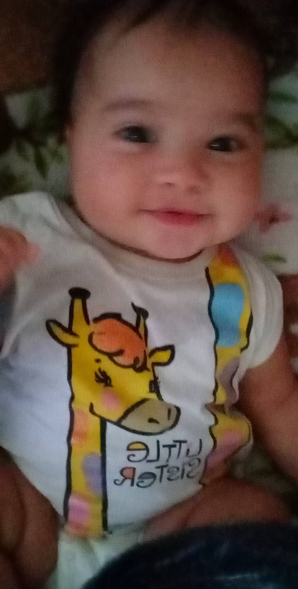 Dannika is registered to the contest to win money with this photo: baby, baby_toddler_clothing, cheek, child, chin, finger, gesture, happy, human_body, mouth, muscle, neck, nose, person, product, sleeve, smile, t_shirt, thumb, toddler