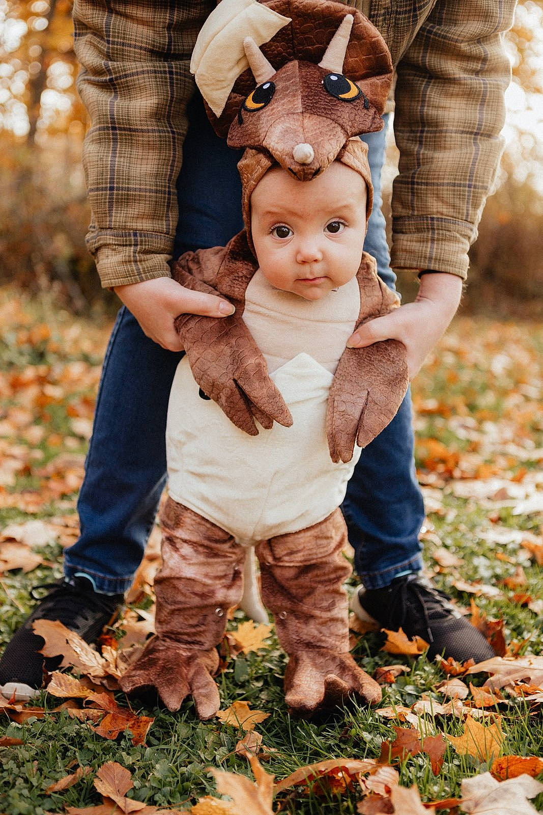Lilith is registered to the contest to win money with this photo: autumn, baby, baby_toddler_clothing, cap, child, deciduous, fur, gesture, grass, happy, hat, head, people_in_nature, person, plant, portrait_photography, sitting, soil, toddler, wood
