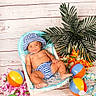 baby, child, striped_hat, striped_diaper, beach_balls, tropical_flowers, palm_tree, chair, smiling, happy, indoor, decor, playful, summer_theme, cute, infant, colorful, portrait, relaxing, fun